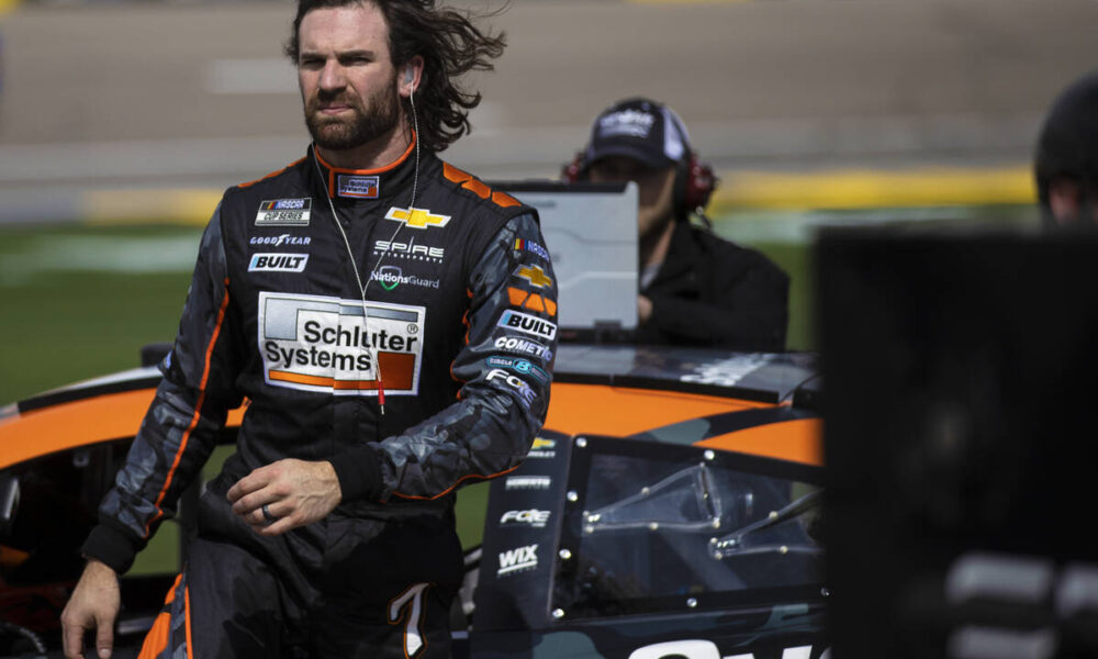 Corey LaJoie stacking pennies in back of the NASCAR pack